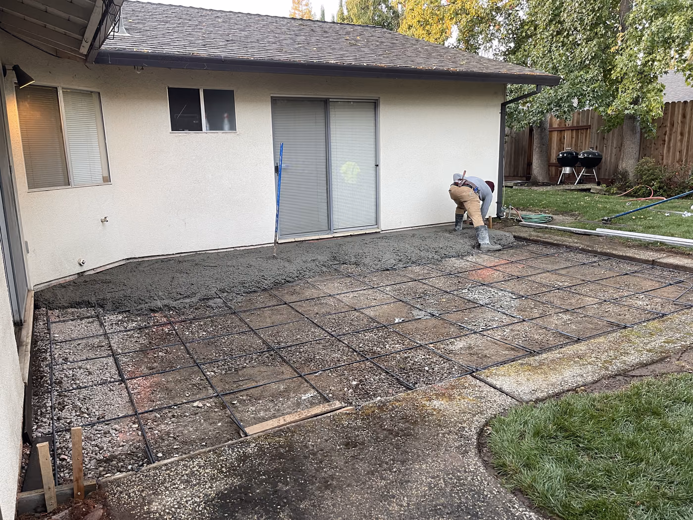 Old brick patio being lifted out before a concrete replacement