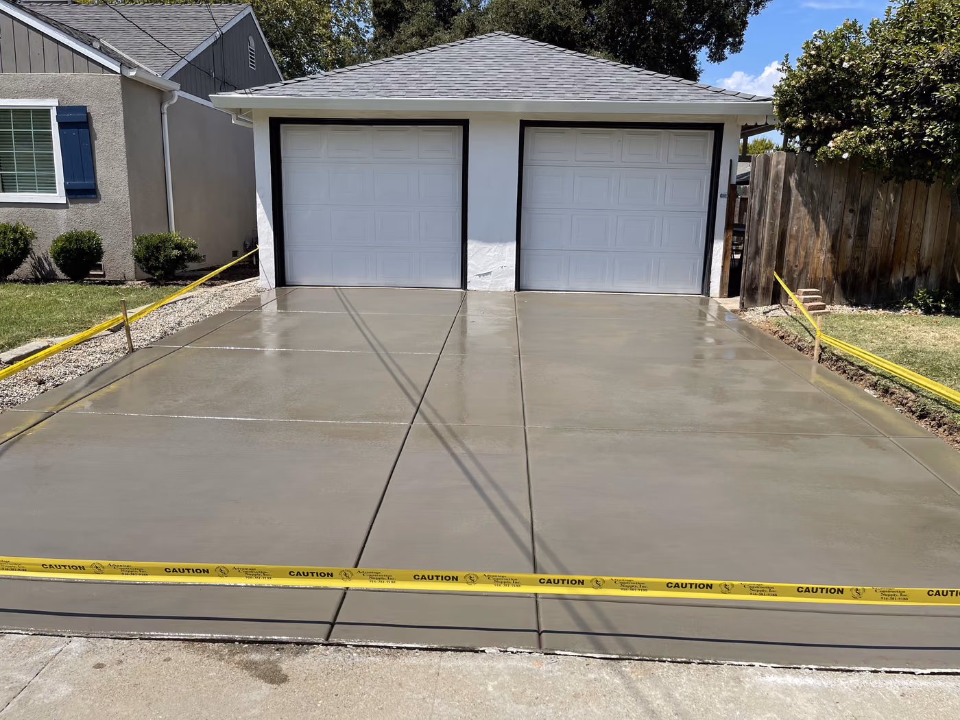 New concrete driveway finished to the garage doors