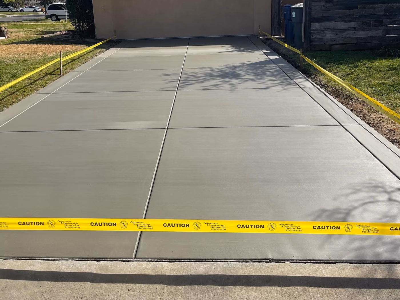 Finished broom-finished concrete driveway replacing gravel