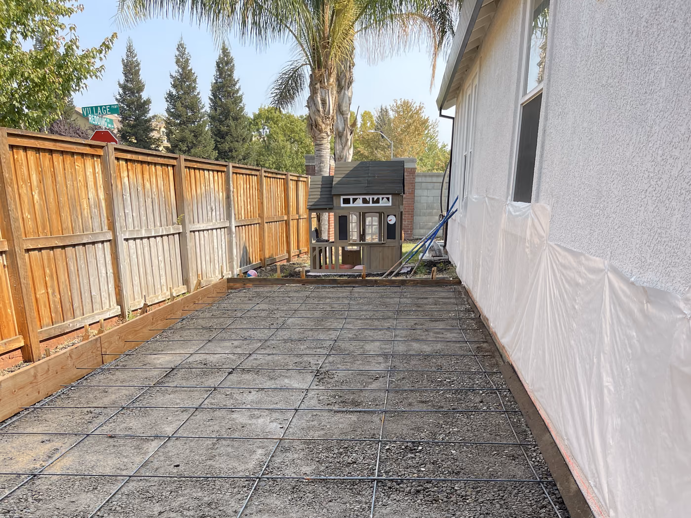 Reinforcement set over a compacted base along a side yard