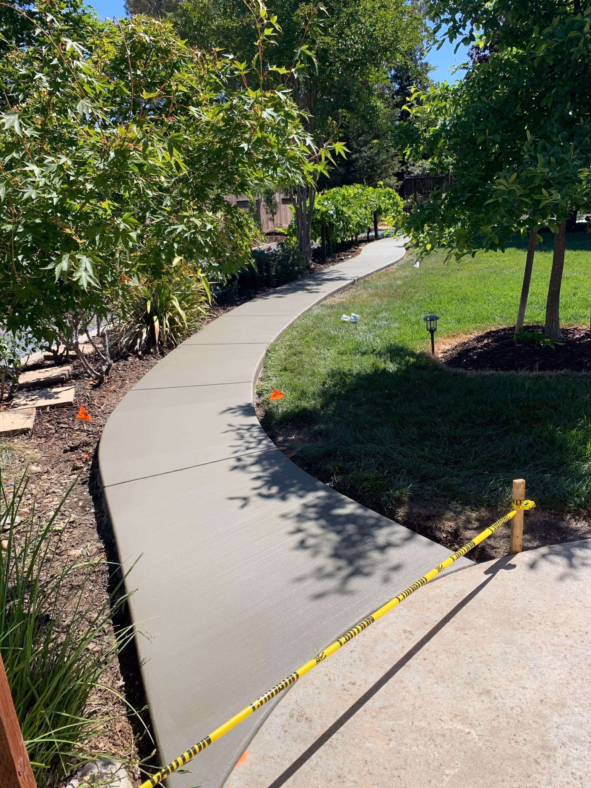 Finished concrete walkway running alongside a Sacramento home