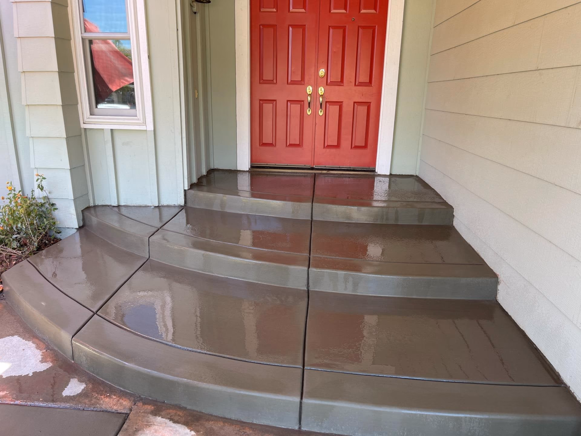 Freshly poured curved concrete entry steps at a Sacramento home