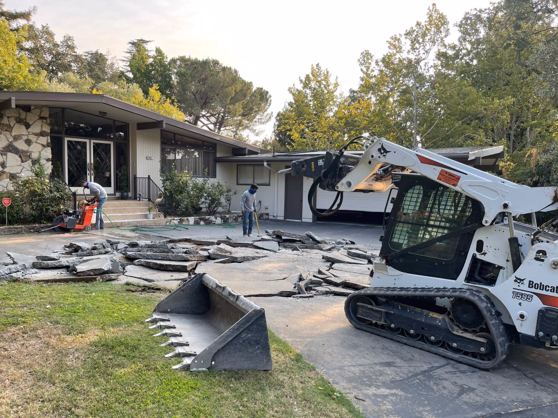 Broken concrete slabs lifted out and stacked for haul-away in Sacramento