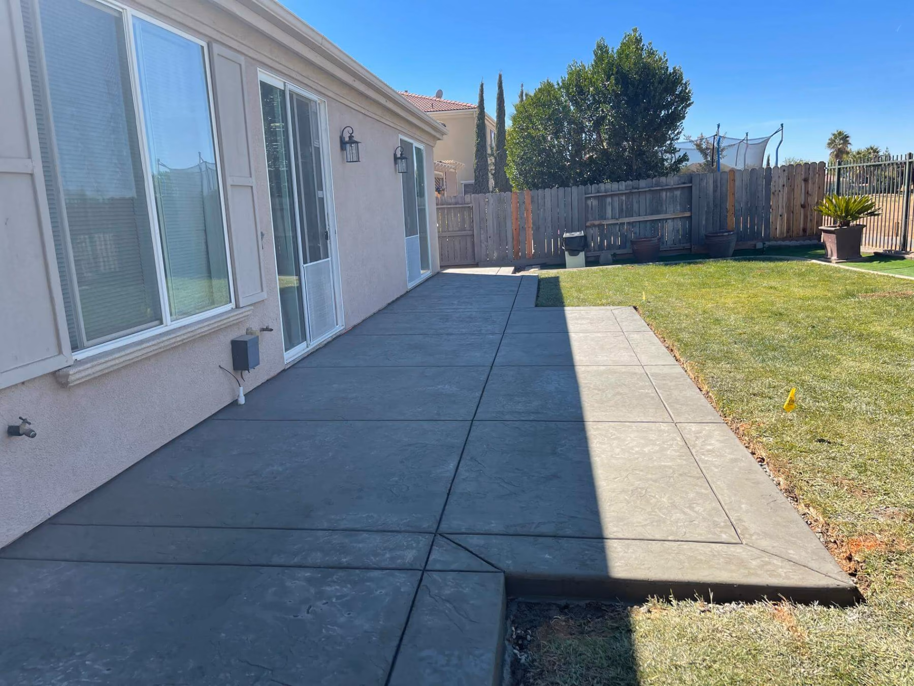Finished concrete walkway running alongside a Sacramento home